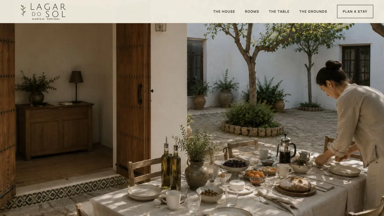 Long outdoor table beneath olive trees on the Lagar do Sol grounds.